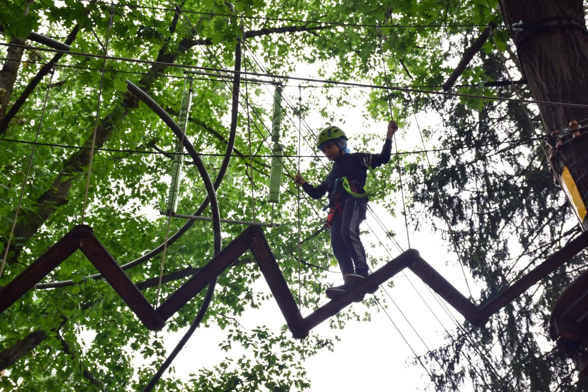 Teenager climbing at the high ropes course